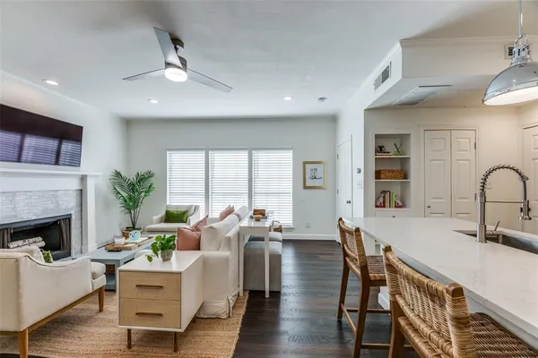 a living room with furniture fireplace and a large window