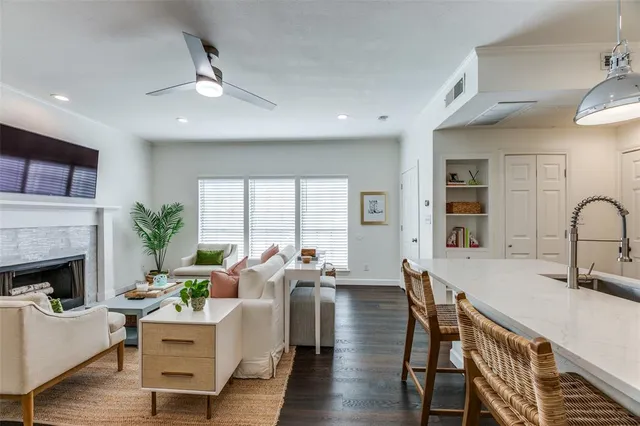 a living room with furniture fireplace and a large window