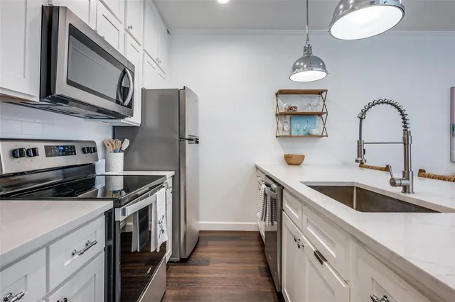 a kitchen with stainless steel appliances granite countertop a sink and a stove