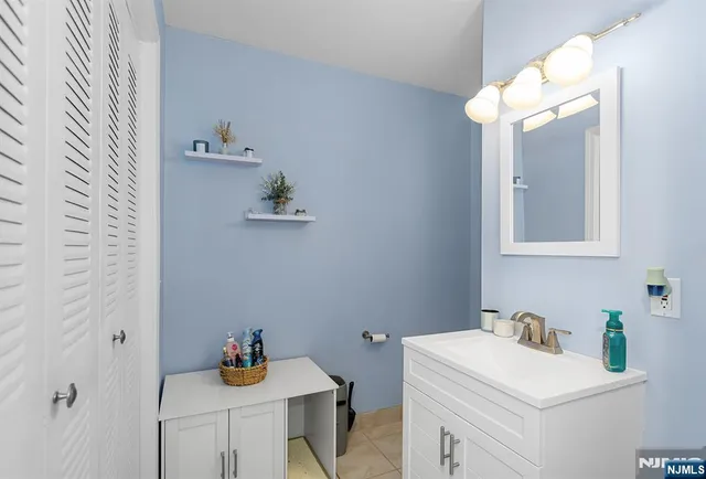 a bathroom with a sink vanity and a mirror