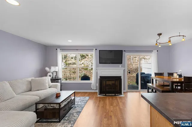 a living room with furniture flat screen tv and a fireplace