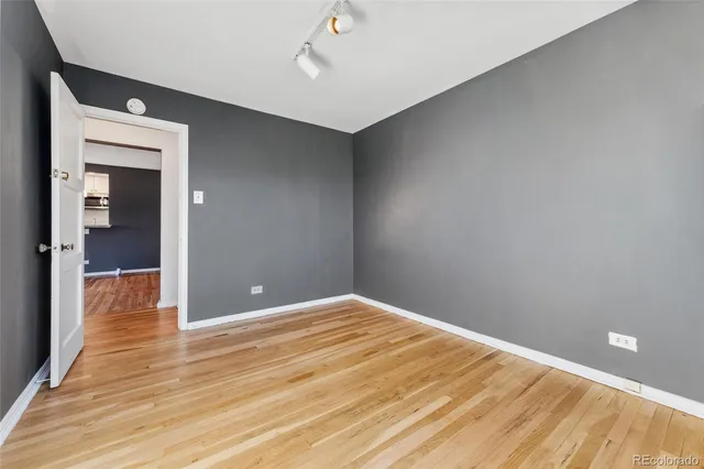 a view of an empty room with wooden floor