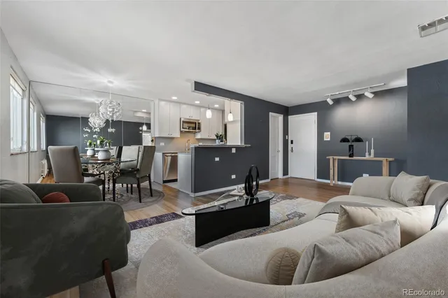 a living room with furniture kitchen view and a dining table
