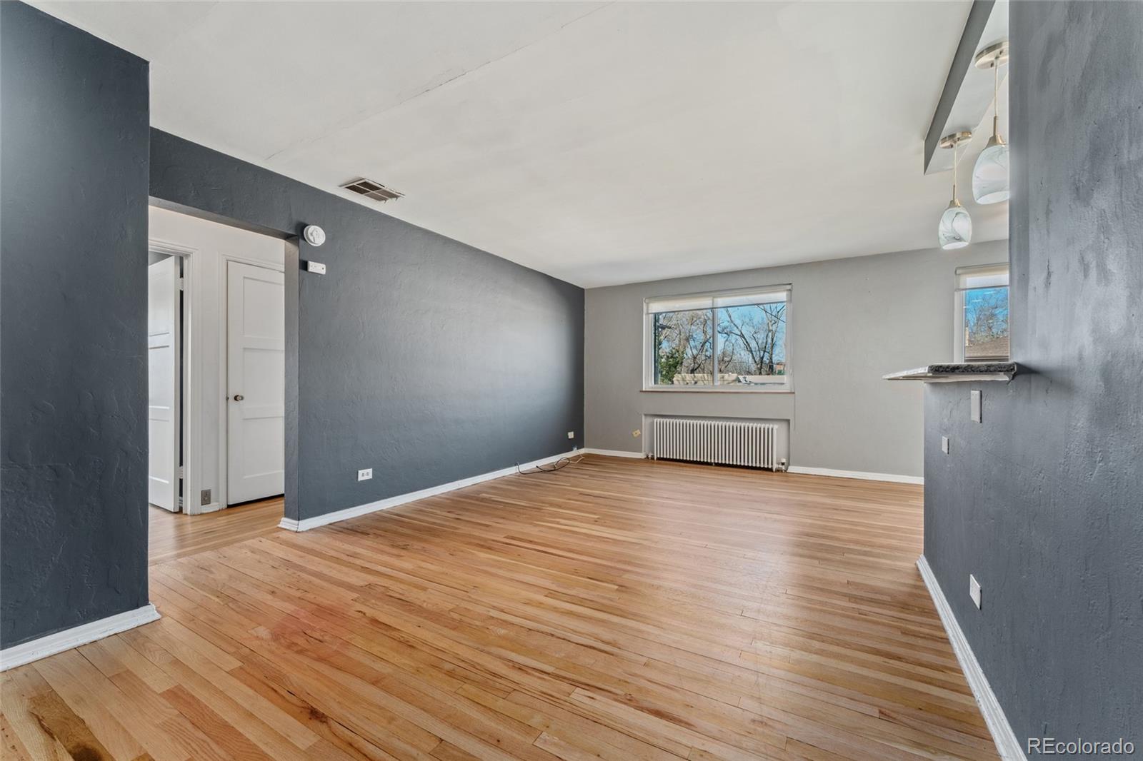 525 Jackson Street, Unit 304 Denver, CO 80206 - Photo 6 of 23 a view of a big room with wooden floor and closet