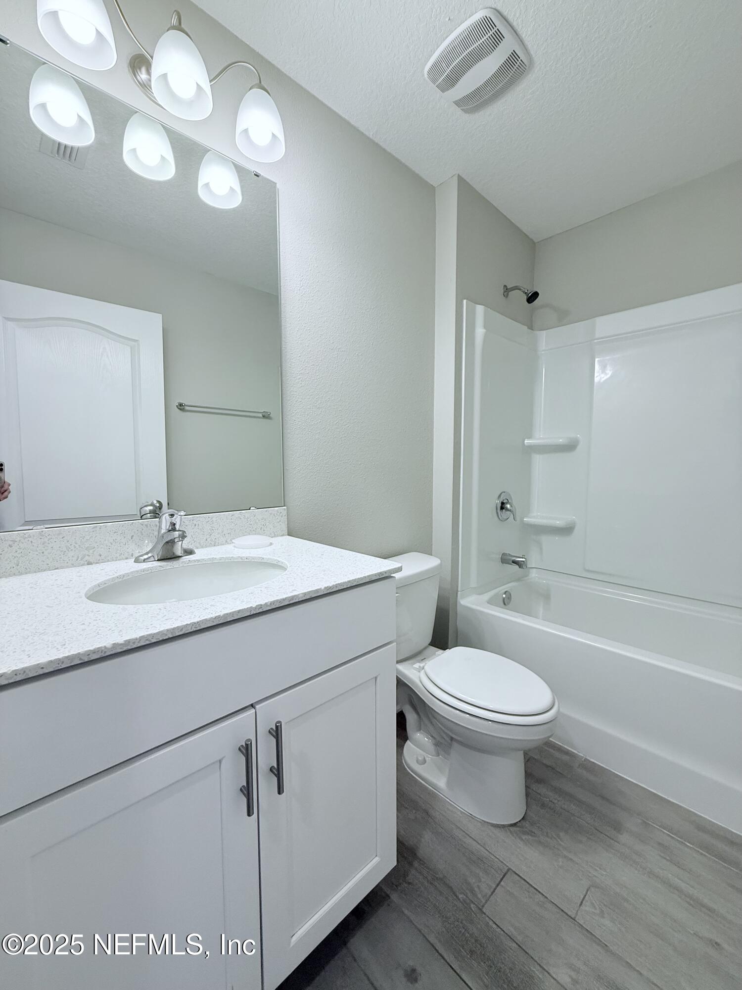 23 Alagon Way Street St. Augustine, FL 32084 - Photo 16 of 39 a bathroom with a toilet a sink a mirror a bathtub and vanity