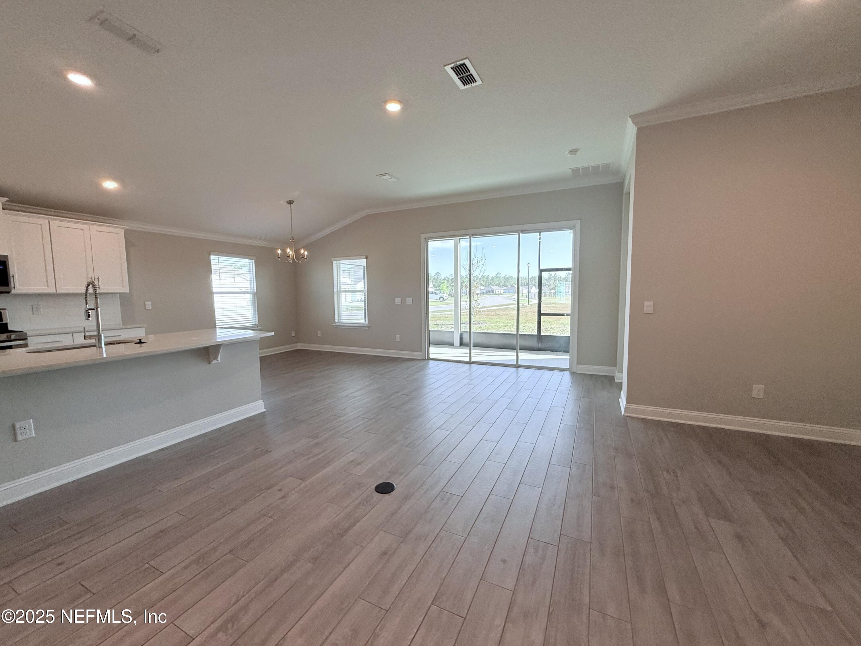 23 Alagon Way Street St. Augustine, FL 32084 - Photo 5 of 39 a view of an empty room with wooden floor and a window