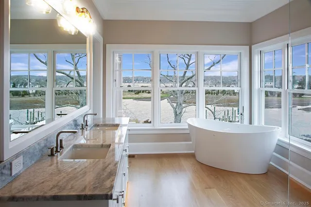 a living room with large windows and a table