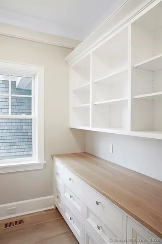 a room with a window cabinets and a wooden floor