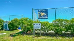 a sign that is sitting on a brick wall