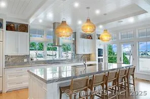 a view of a dining room with furniture and a large window
