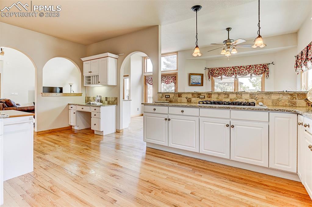 750 Bowstring Road Monument, CO 80132 - Photo 11 of 34 a view of a kitchen with kitchen island a sink stainless steel appliances and cabinets