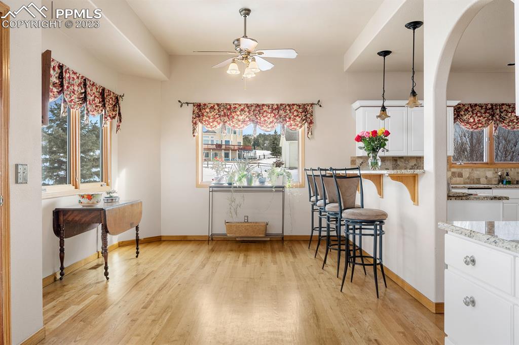750 Bowstring Road Monument, CO 80132 - Photo 14 of 34 a living room with furniture and a wooden floor