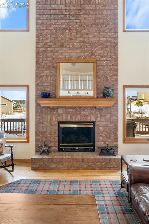 750 Bowstring Road Monument, CO 80132 - Photo 17 of 34 a living room with a fireplace and a fireplace