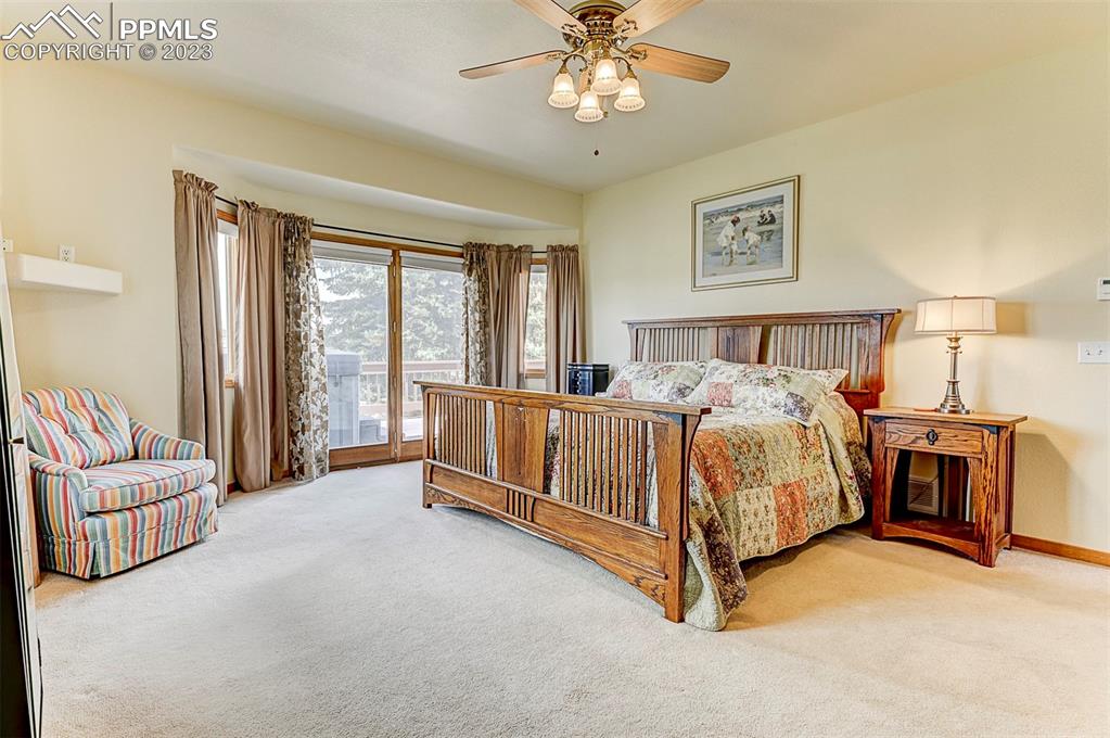 750 Bowstring Road Monument, CO 80132 - Photo 20 of 34 a bed room with a bed and a couch