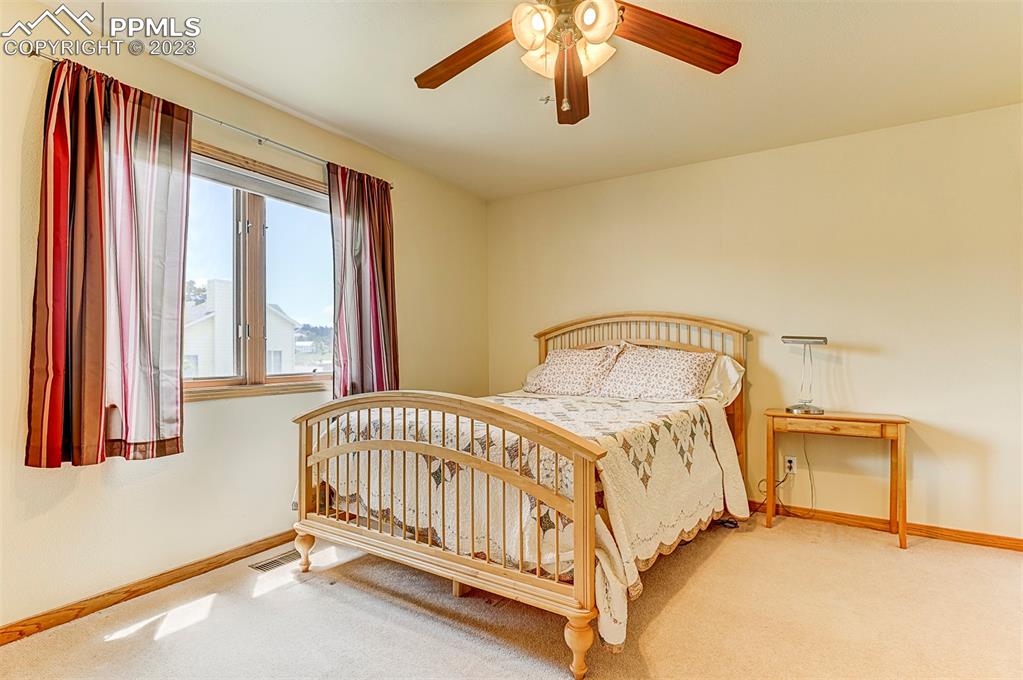 750 Bowstring Road Monument, CO 80132 - Photo 24 of 34 a bedroom with a bed and window