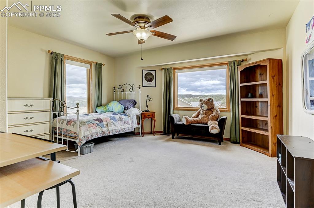750 Bowstring Road Monument, CO 80132 - Photo 25 of 34 a bedroom with furniture and a large window