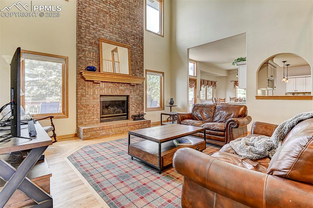 750 Bowstring Road Monument, CO 80132 - Photo 3 of 34 a living room with couches coffee table and a fireplace