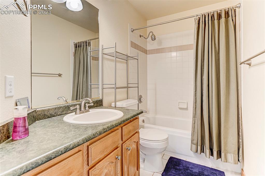 750 Bowstring Road Monument, CO 80132 - Photo 31 of 34 a bathroom with a granite countertop sink toilet and shower