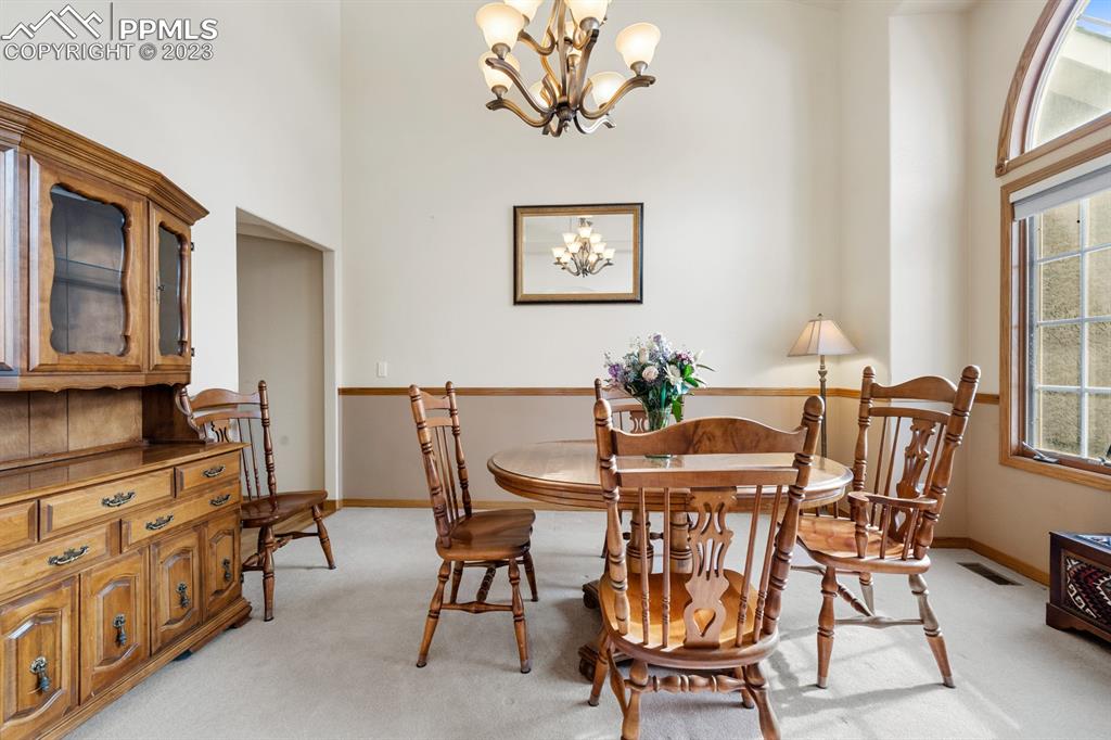750 Bowstring Road Monument, CO 80132 - Photo 9 of 34 a view of a dining room with furniture and a chandelier