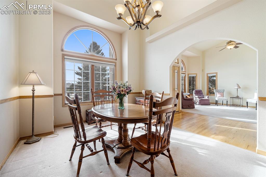 750 Bowstring Road Monument, CO 80132 - Photo 10 of 34 a view of a dining room with furniture and a chandelier