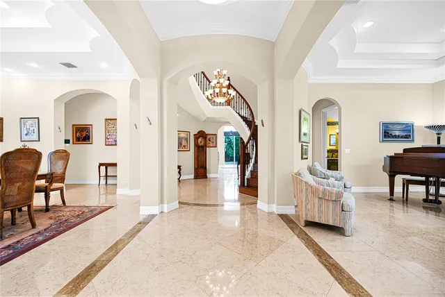 a kitchen with stainless steel appliances granite countertop a stove top oven a sink a dining table and chairs