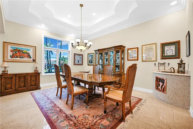 a view of a dining room with furniture large windows and wooden floor