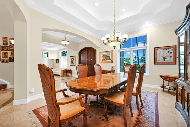a view of kitchen with stainless steel appliances kitchen island granite countertop a table and chairs in it