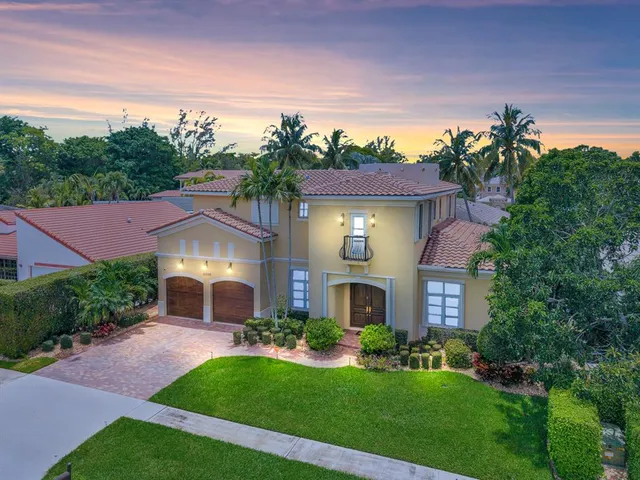 a front view of a house with a garden and plants