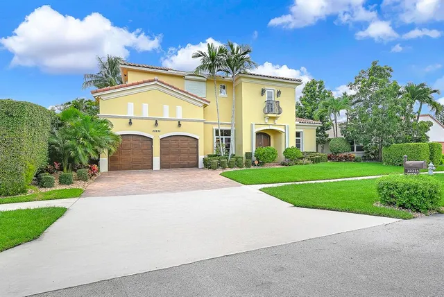 a front view of a house with a garden and yard