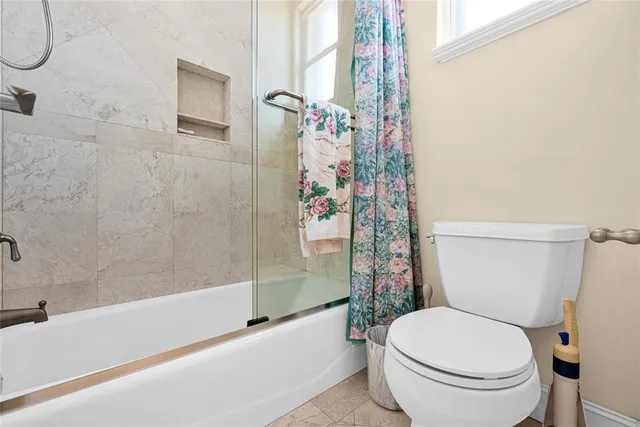 a front view of a house with swimming pool and porch with furniture