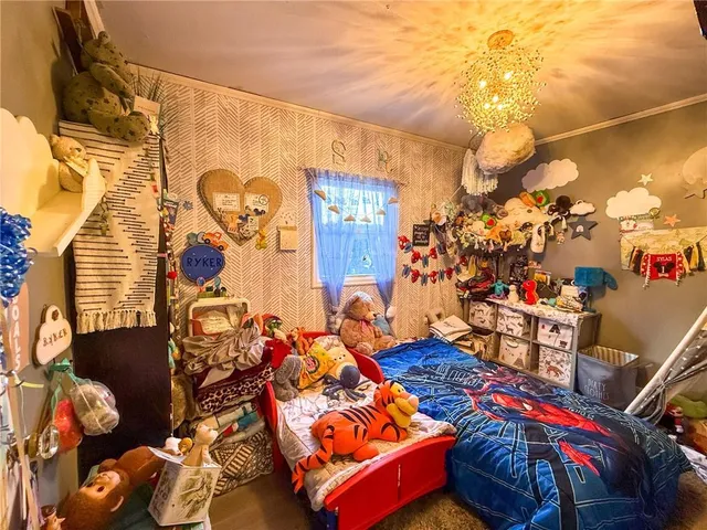 a view of gym equipment with clothes and bicycles