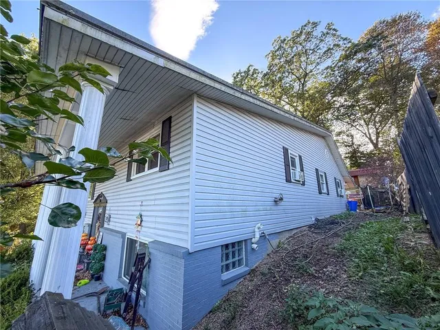 a view of a house with a yard and potted plants