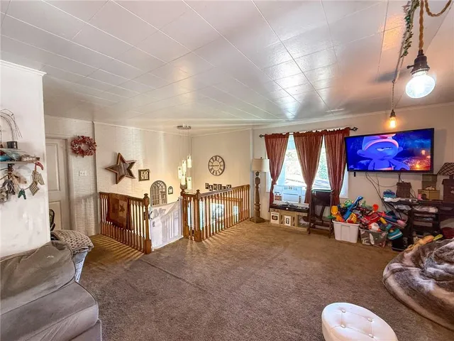 a living room with furniture a window and gym equipment