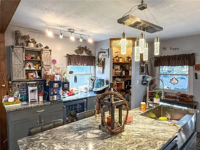 a room with lots of furniture and a chandelier