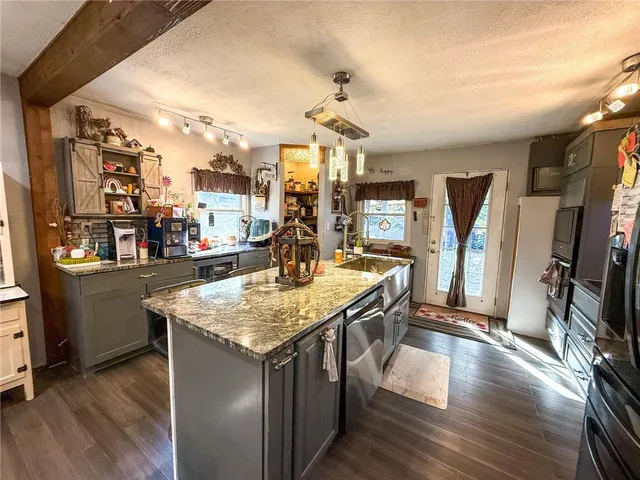 a kitchen with stainless steel appliances granite countertop a stove and a refrigerator