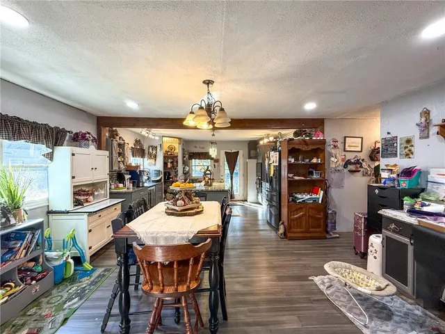 a view of a dining room with furniture and chandelier