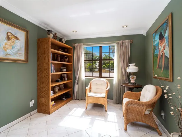 a living room with furniture and a bookshelf