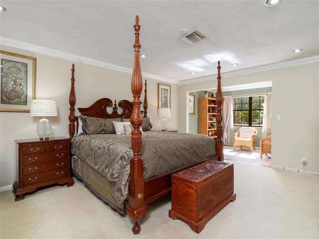 a bed room with a bed window and a dresser