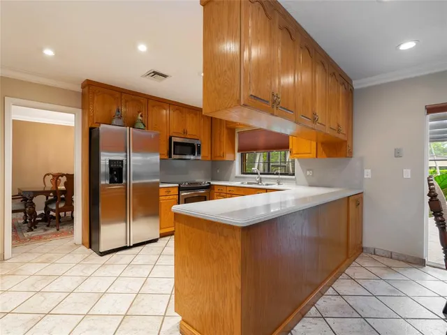 a kitchen with stainless steel appliances granite countertop a sink and a refrigerator