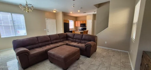 a living room with furniture and a chandelier