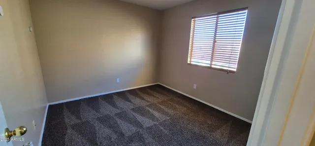 an empty room with closet area