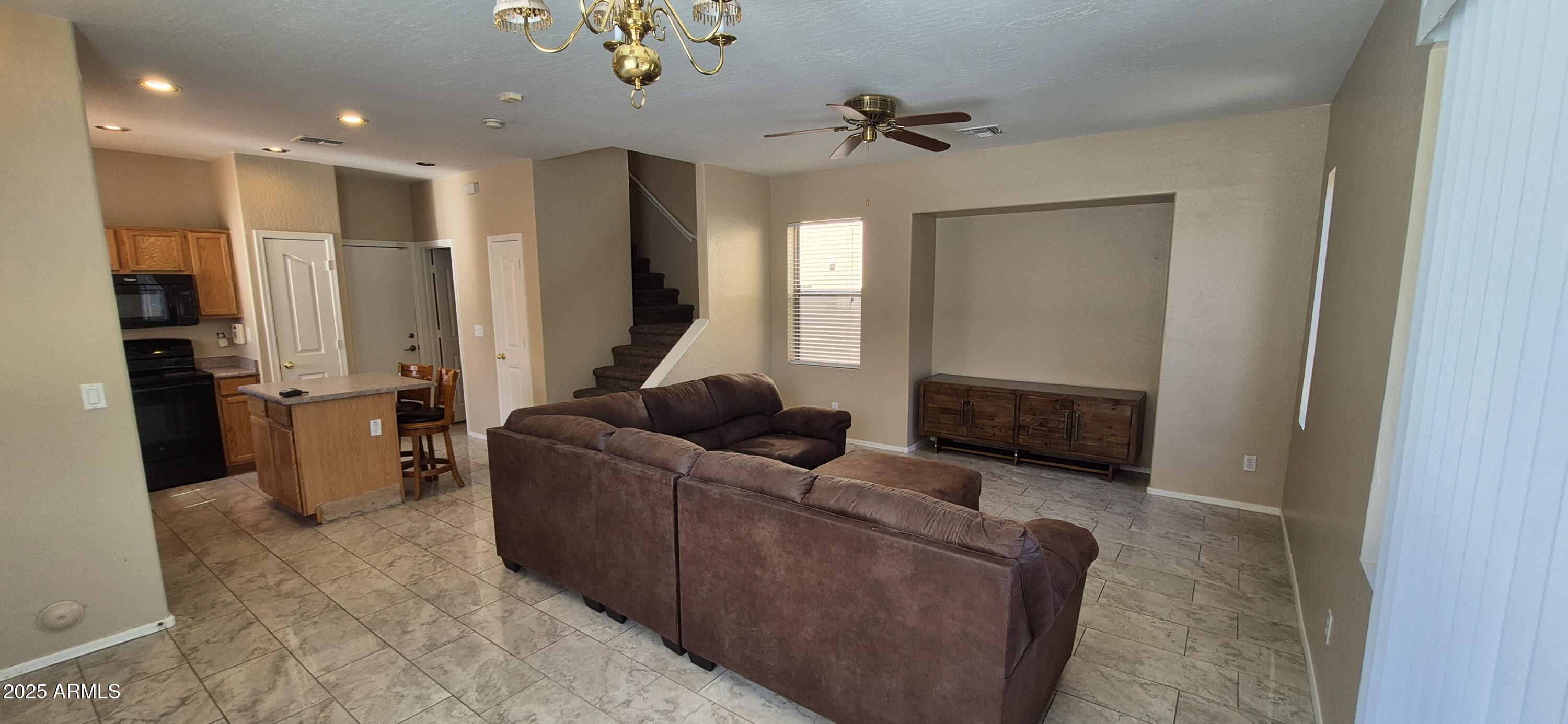 1347 East Dunbar Drive Phoenix, AZ 85042 - Photo 17 of 19 a living room with furniture and a flat screen tv