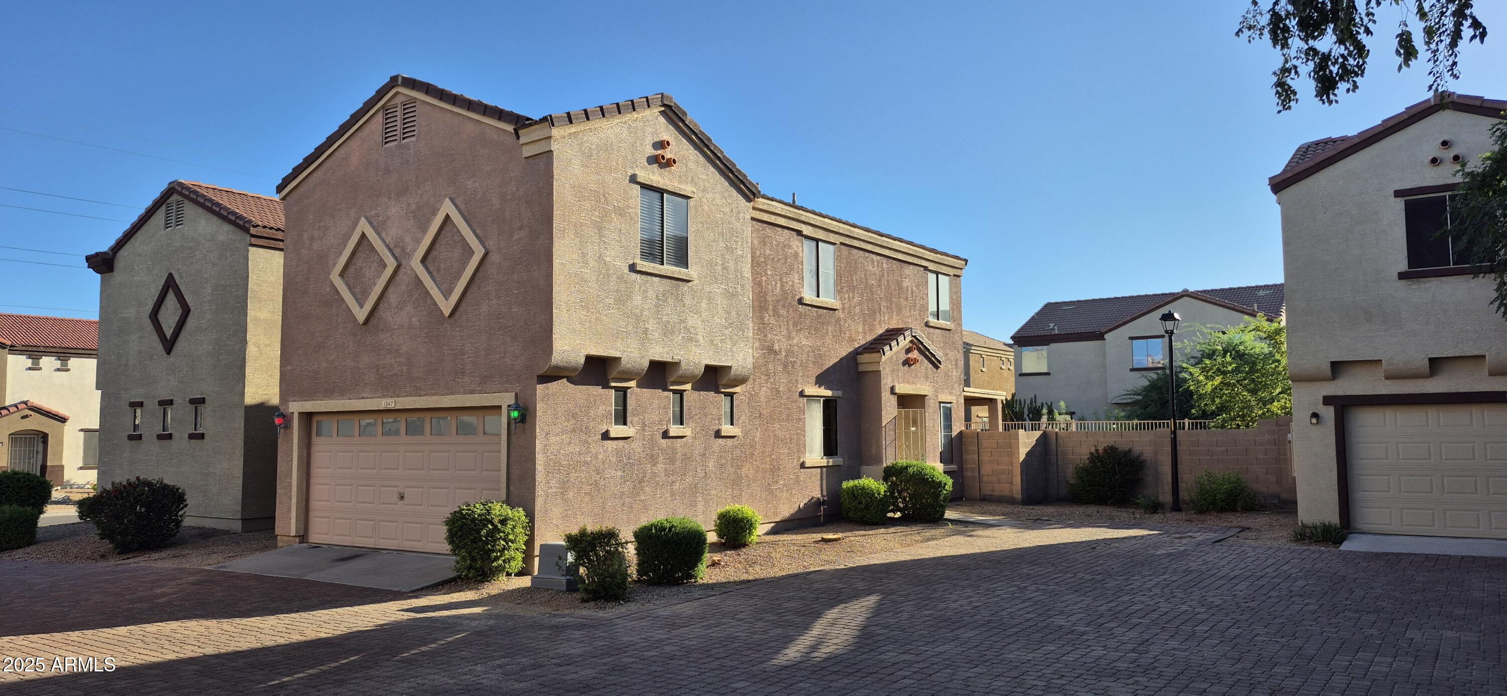 1347 East Dunbar Drive Phoenix, AZ 85042 - Photo 18 of 19 a front view of a house with garage