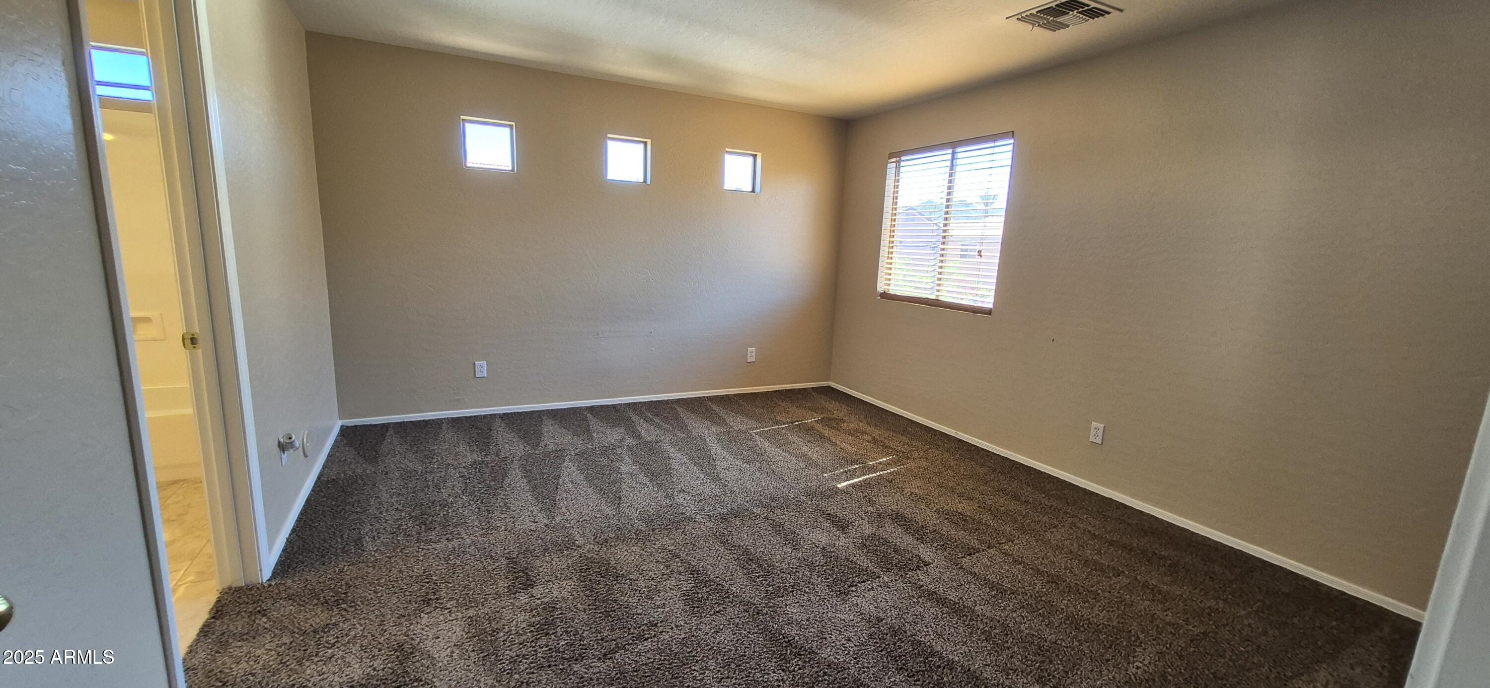 1347 East Dunbar Drive Phoenix, AZ 85042 - Photo 4 of 19 an empty room with windows