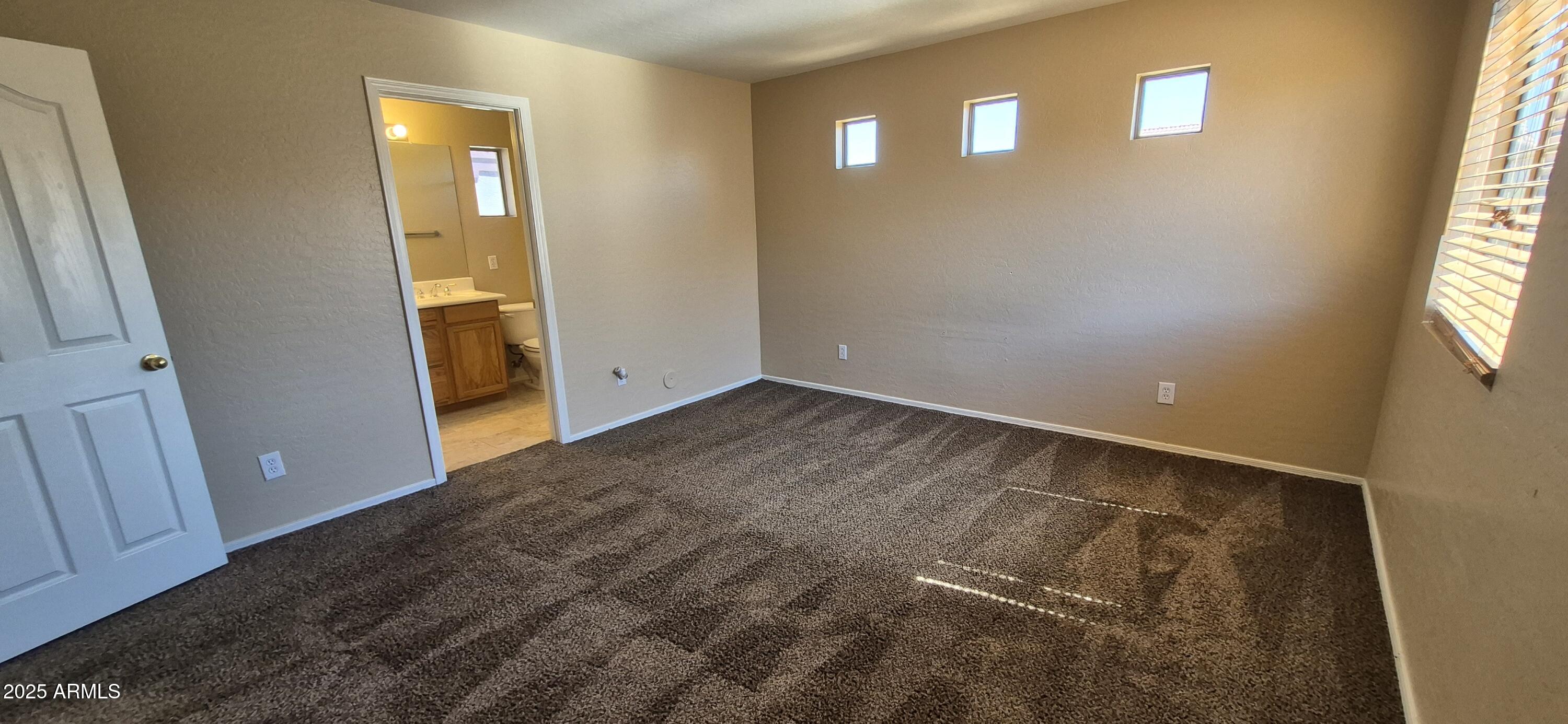 1347 East Dunbar Drive Phoenix, AZ 85042 - Photo 5 of 19 an empty room with windows