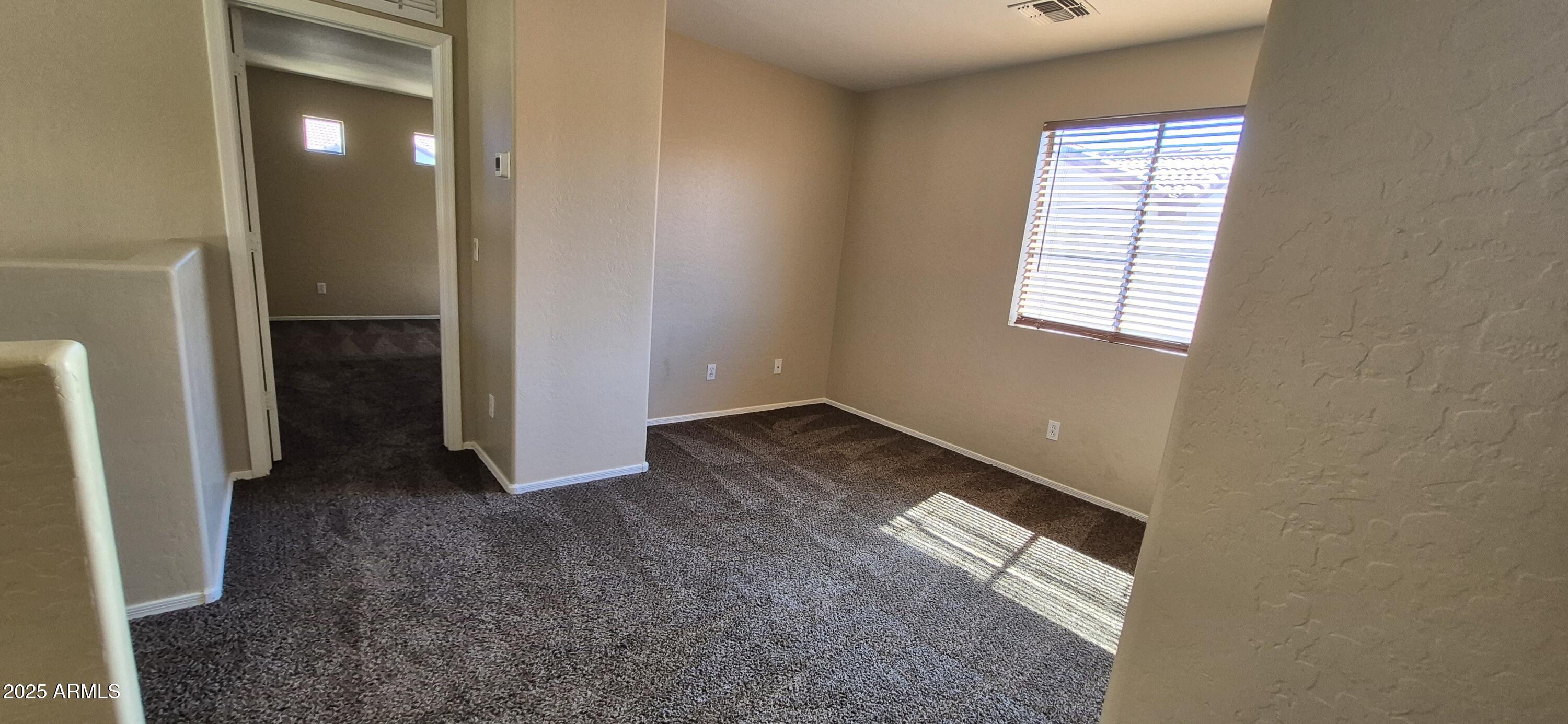 1347 East Dunbar Drive Phoenix, AZ 85042 - Photo 7 of 19 an empty room with windows