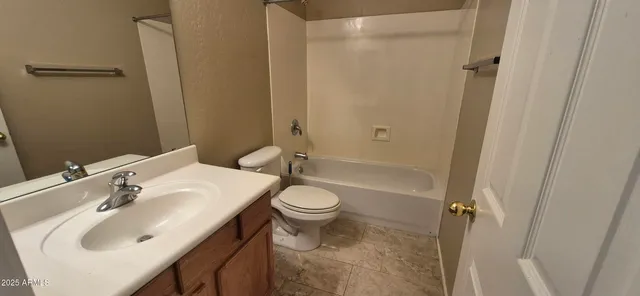 a white toilet sitting next to a bath tub