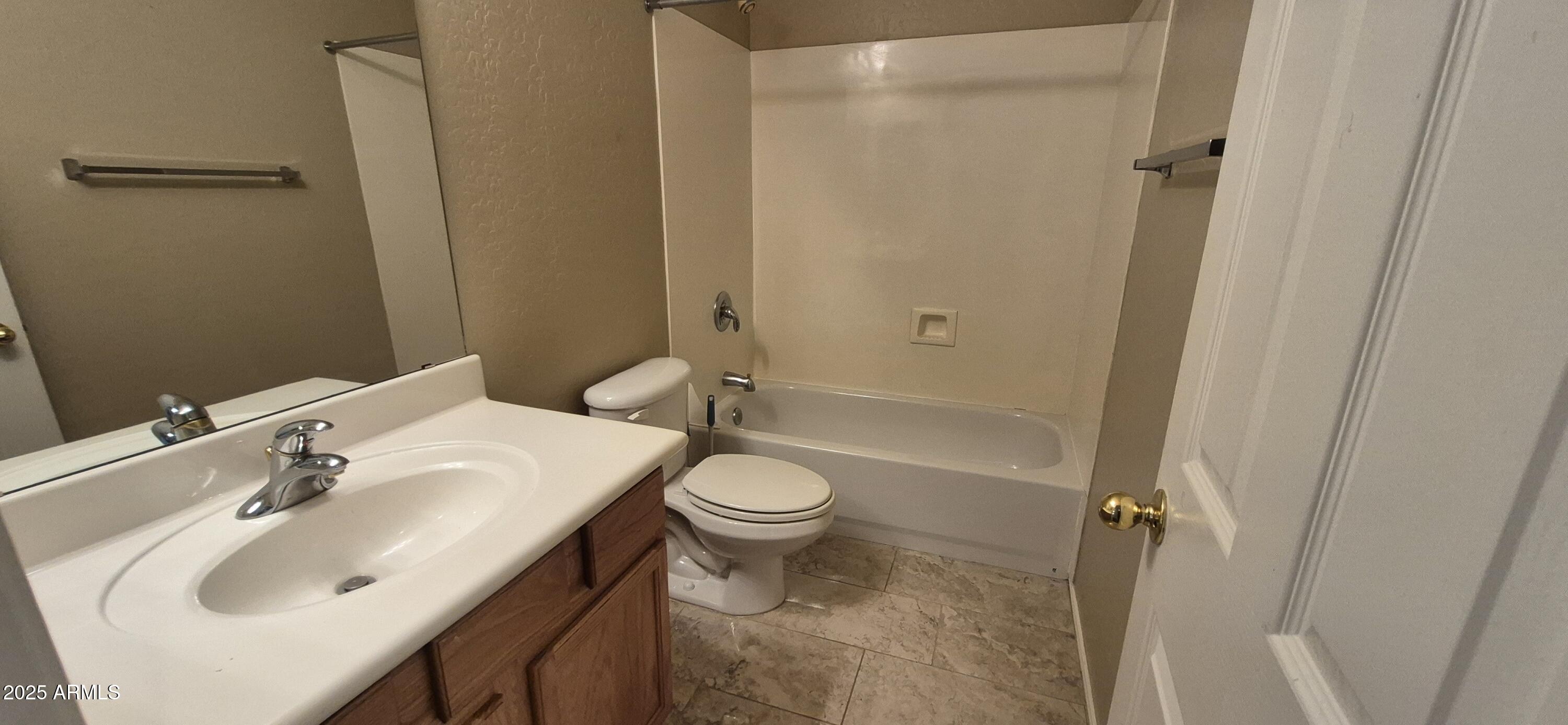 1347 East Dunbar Drive Phoenix, AZ 85042 - Photo 9 of 19 a bathroom with a sink toilet and shower