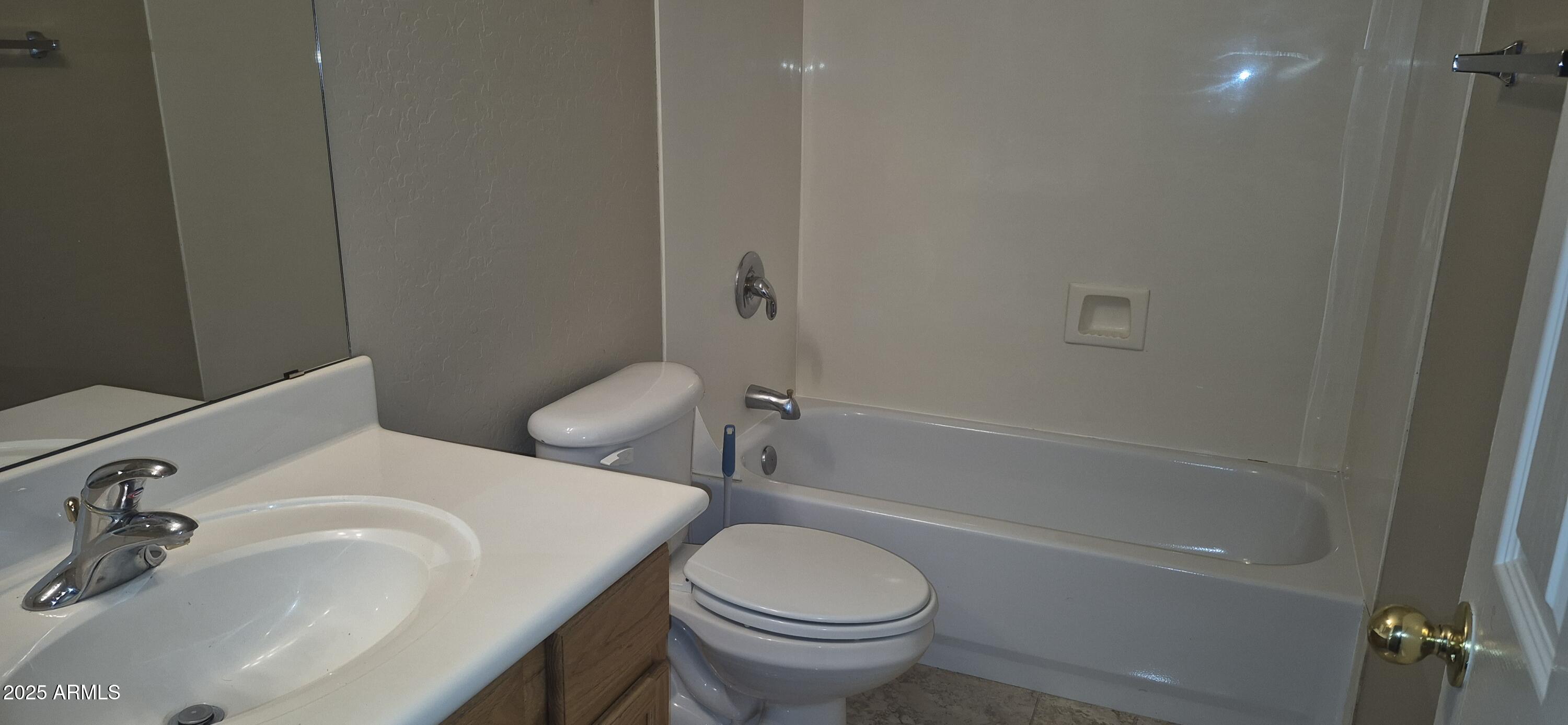 1347 East Dunbar Drive Phoenix, AZ 85042 - Photo 10 of 19 a white toilet sitting next to a bath tub