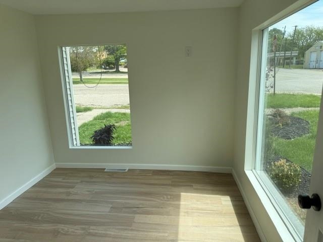 314 South High Street Granville, IL 61326 - Photo 14 of 22 a view of an empty room with wooden floor and a window